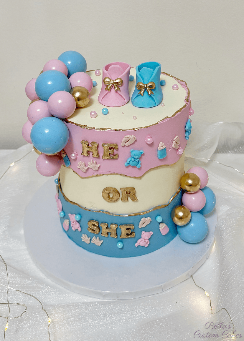 Charming single-tier baby shower cake with he or she tag