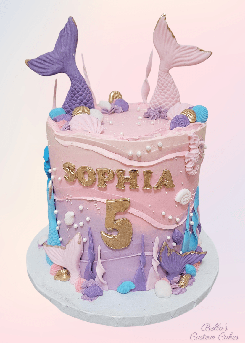 TBeautiful cake decorated with ocean waves and a mermaid tail topper