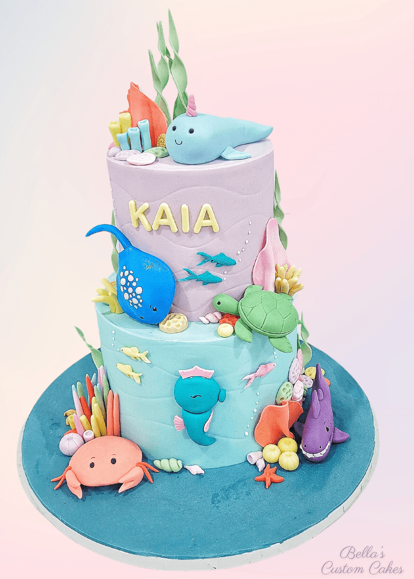 Two-tier mermaid cake featuring sea animals and underwater flora