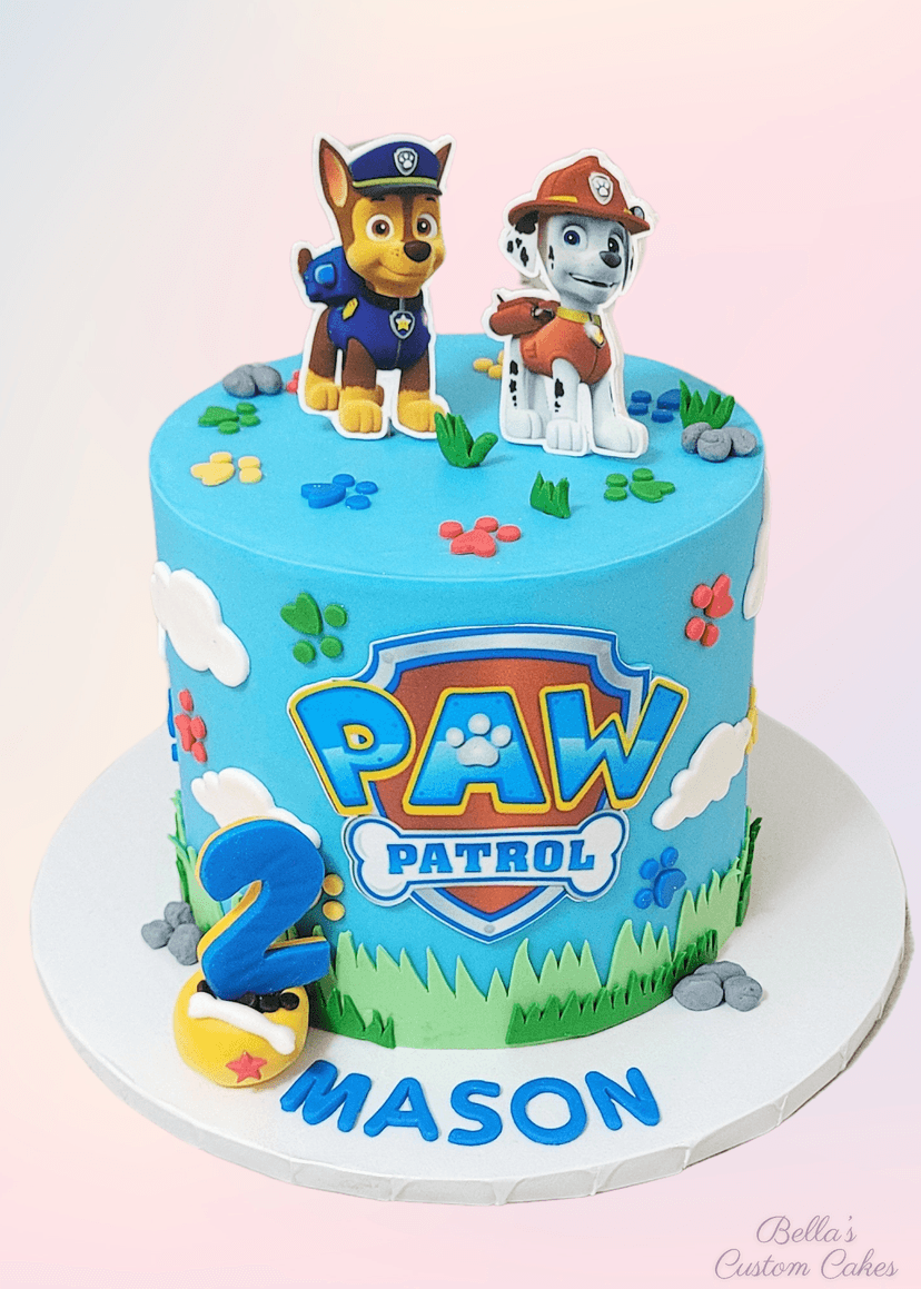 Paw Patrol cake with colorful badges and paw prints
