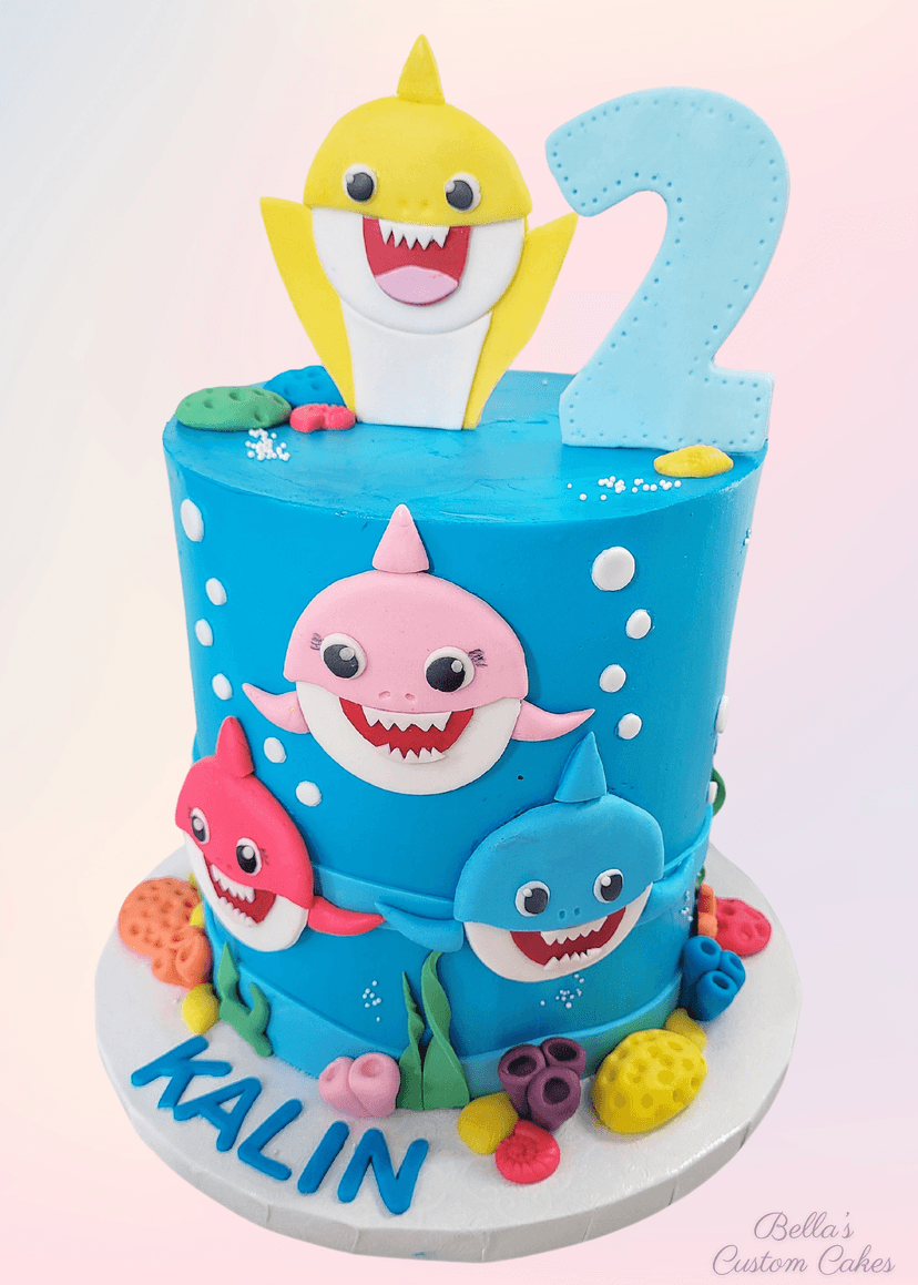 Round shark cake featuring coral reef designs and edible fish
