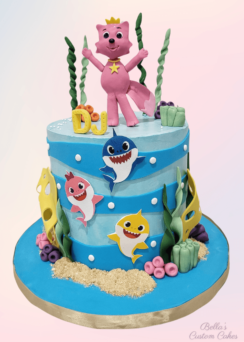 Shark cake with vibrant blue icing and realistic sharks on top