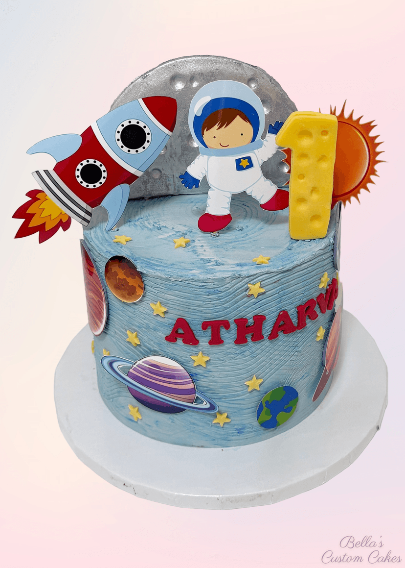 Space-themed cake featuring planets, stars, and a rocket ship in vibrant colors