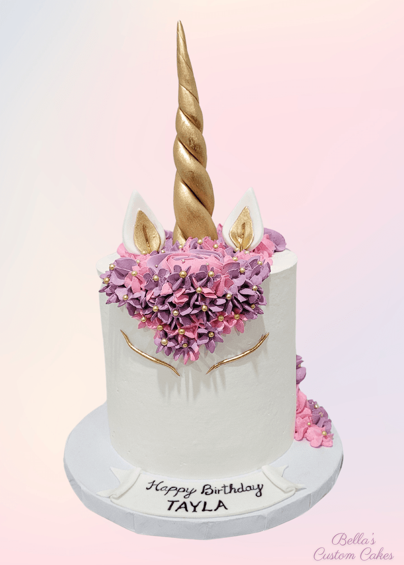 Whimsical pastel unicorn cake decorated with stars and clouds